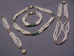 [ 17.5 in. three strand, white, pearl necklace and matching 7.5 in. bracelet set with jade beads. ]